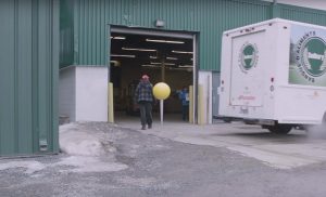 Truck backing up into a loading dock of a building