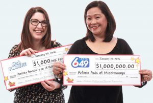 Two winners holding cheques