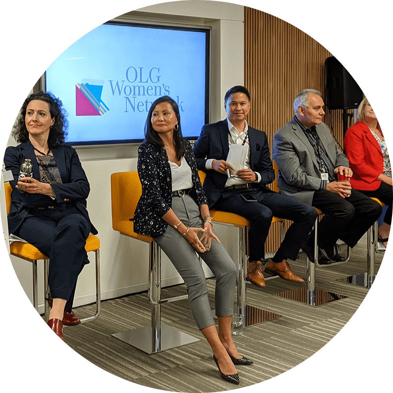 Three women and two men presenting and brainstorming during an OLG Women's Network session.