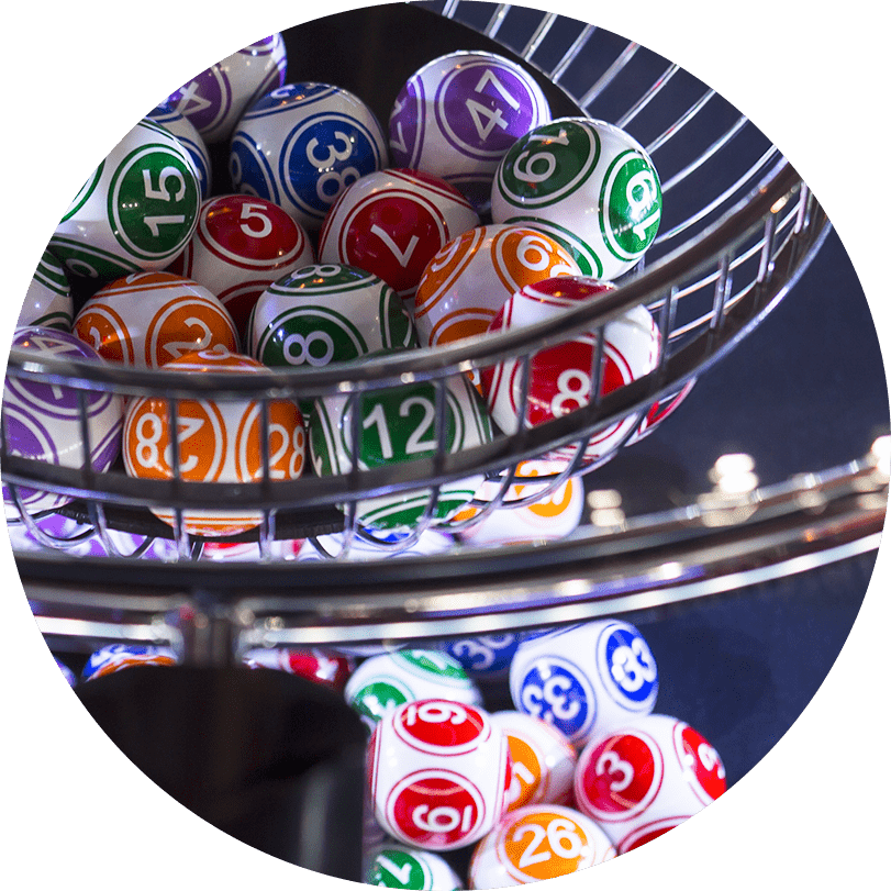 A lottery ball machine containing multiple lottery balls of different numbers and colours.