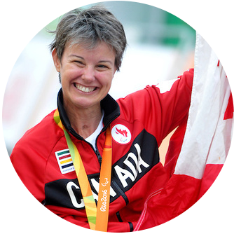 Competitive Para cycler Shelley Gautier, holding a Canadian flag during the 2016 Rio Olympics.