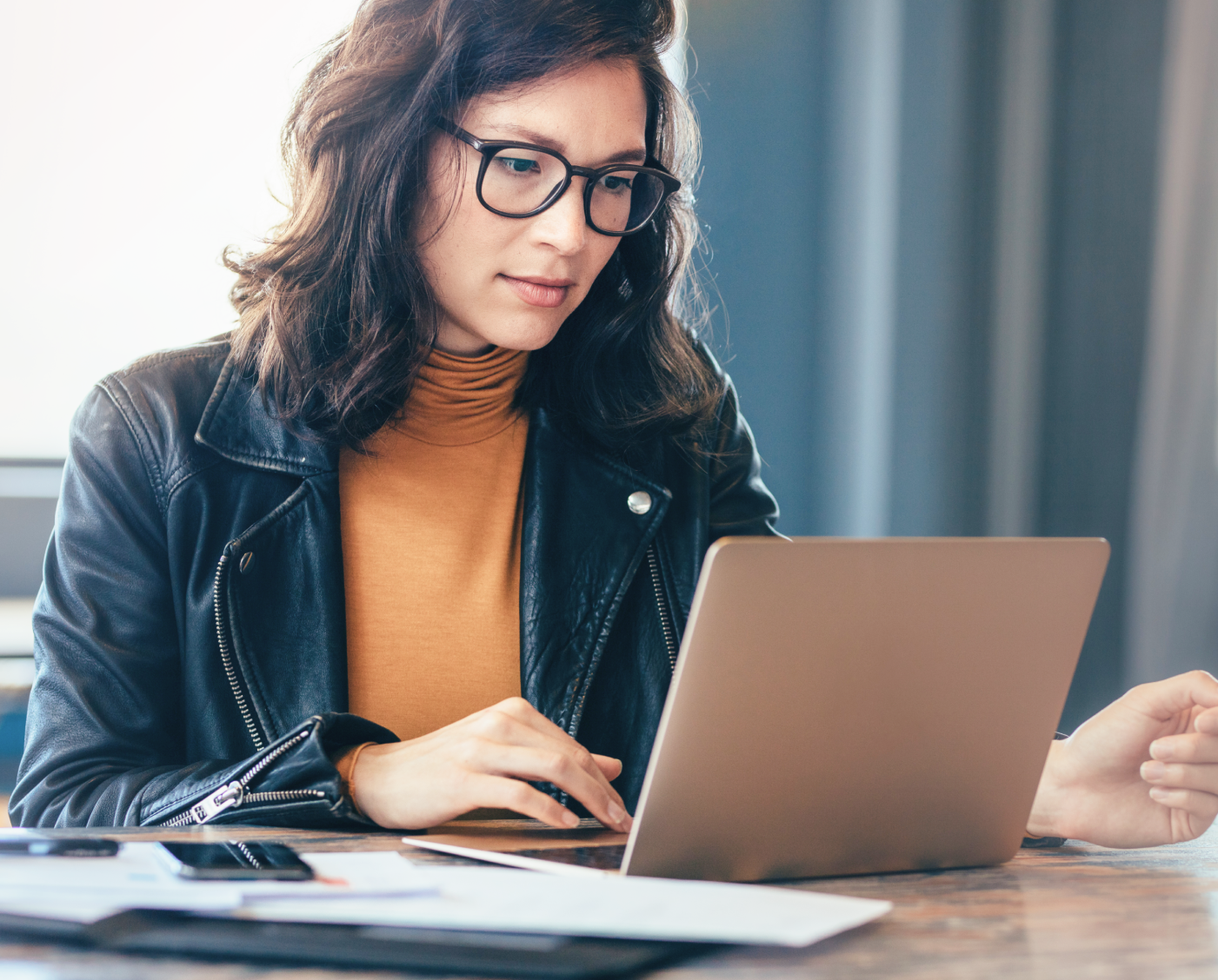 OLG CPA Certificate Program banner featuring a person working on a laptop