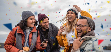 Group of four happy people who have just won an olg lottery game surrounded by confetti