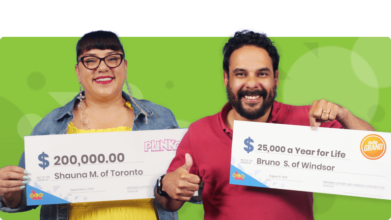 Two people holding a lottery cheque.