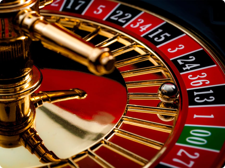 View of a Roulette wheel with a silver ball shown on the number 13.
