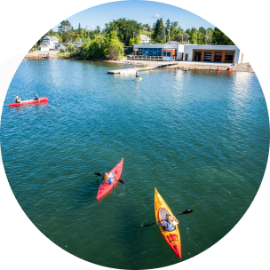 Top view of a body of water with kayaks in the water.