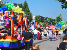 View of a parade with multi-coloured balloons.